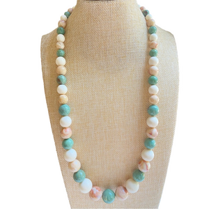 Swirly acrylic bead necklace in graduated single strand of cream tan and green